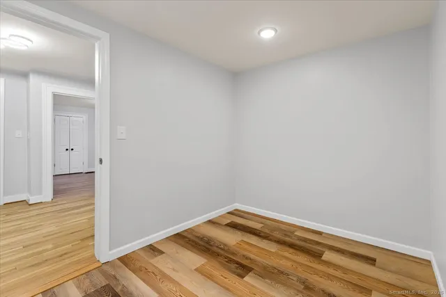 a view of a room with wooden floor