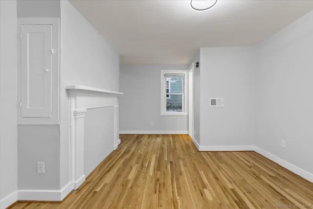 a view of a room with wooden floor staircase and a bathroom