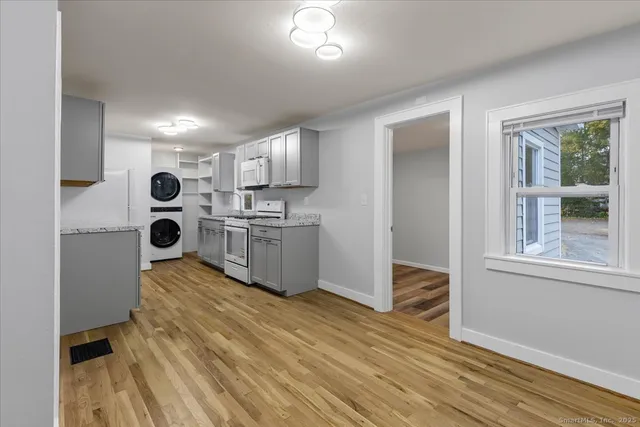 a kitchen with stainless steel appliances a stove a sink and a refrigerator