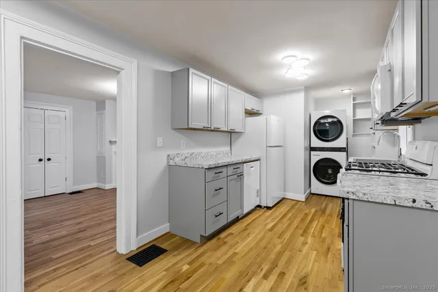 a kitchen with stainless steel appliances granite countertop a refrigerator and a stove top oven