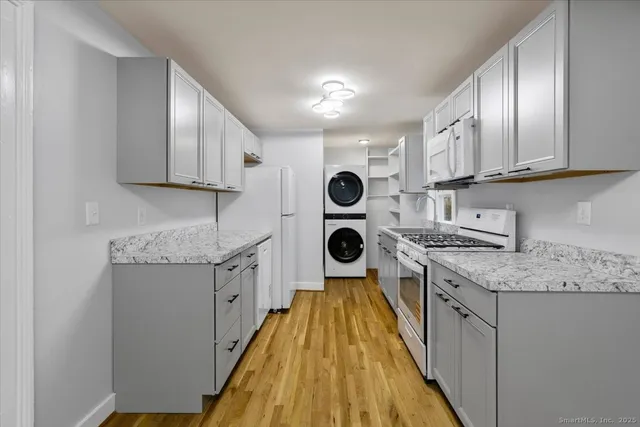 a kitchen with a sink a stove and cabinets