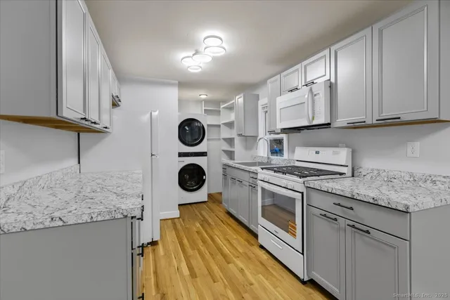a kitchen with a stove a sink and a refrigerator