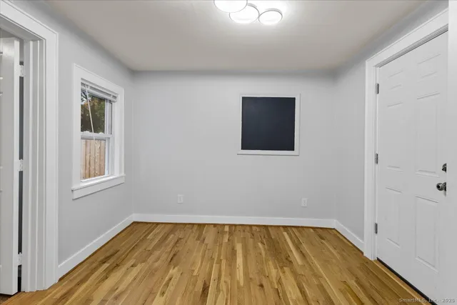 a view of a room with wooden floor and windows