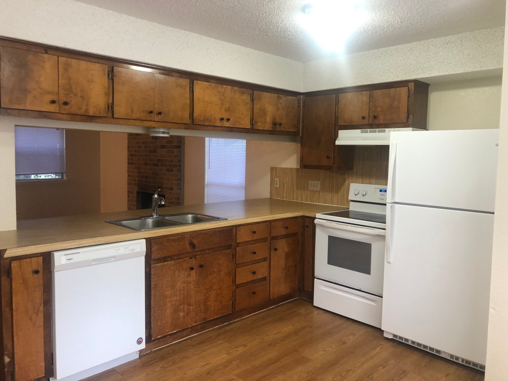 3308 Dunliegh Drive, Unit A Austin, TX 78745 - Photo 5 of 10 a kitchen with stainless steel appliances a refrigerator sink and cabinets