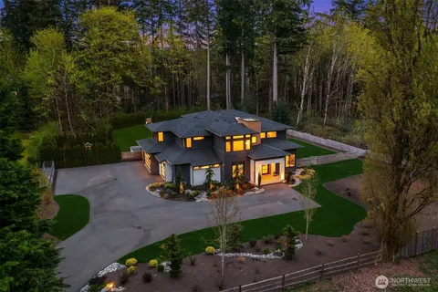 an aerial view of a house with swimming pool garden and patio