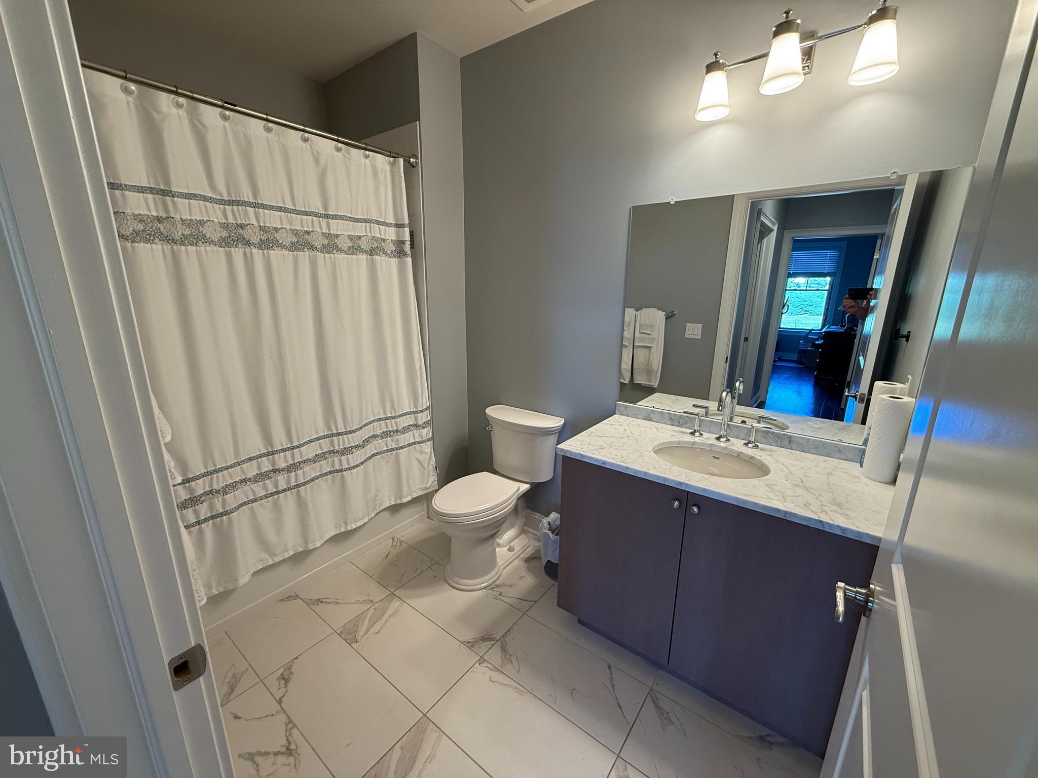 200 North Sycamore Street, Unit 2I Newtown, PA 18940 - Photo 15 of 27 a bathroom with a sink vanity mirror and toilet