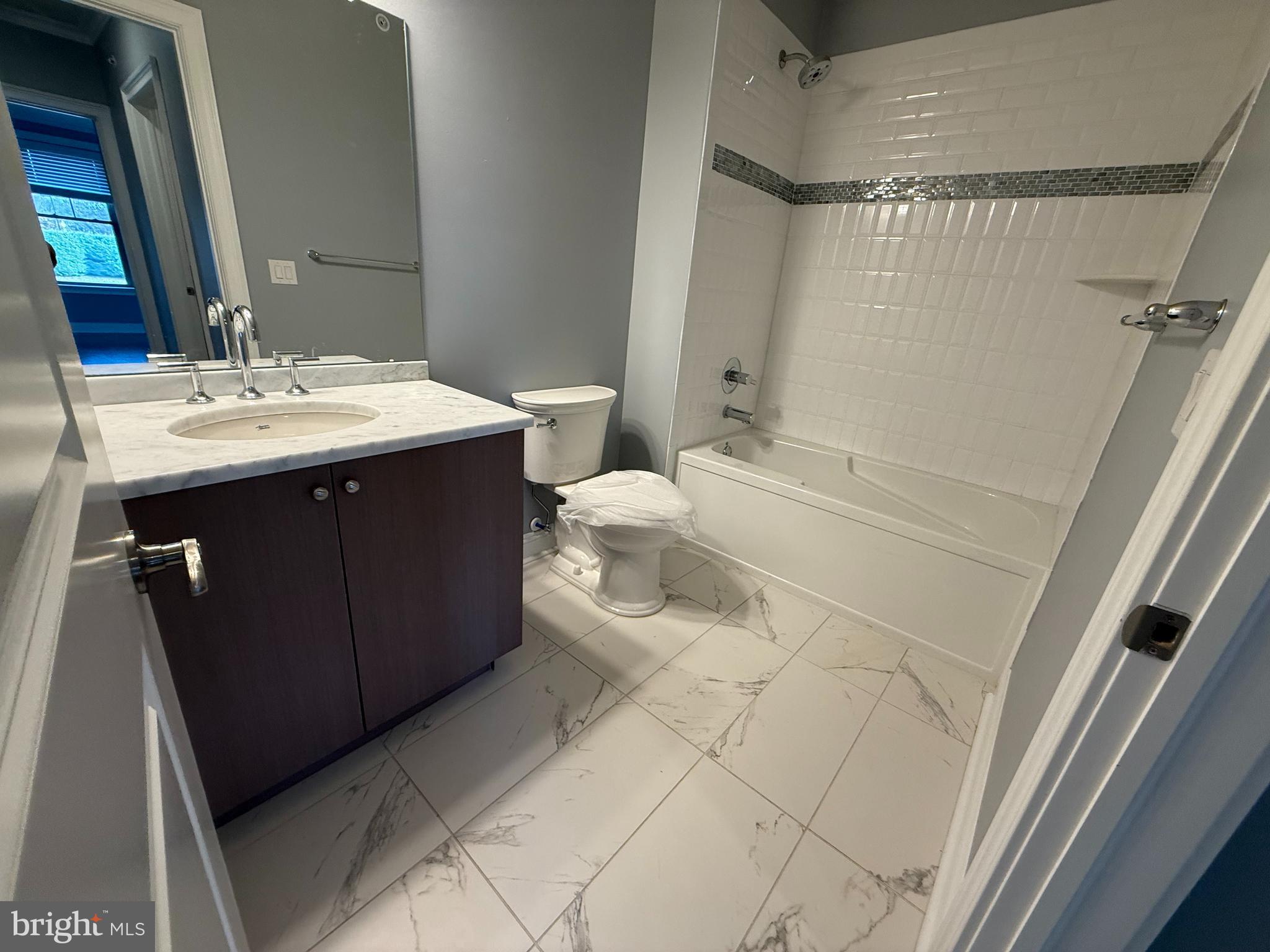 200 North Sycamore Street, Unit 2I Newtown, PA 18940 - Photo 21 of 27 a bathroom with a sink a toilet and shower