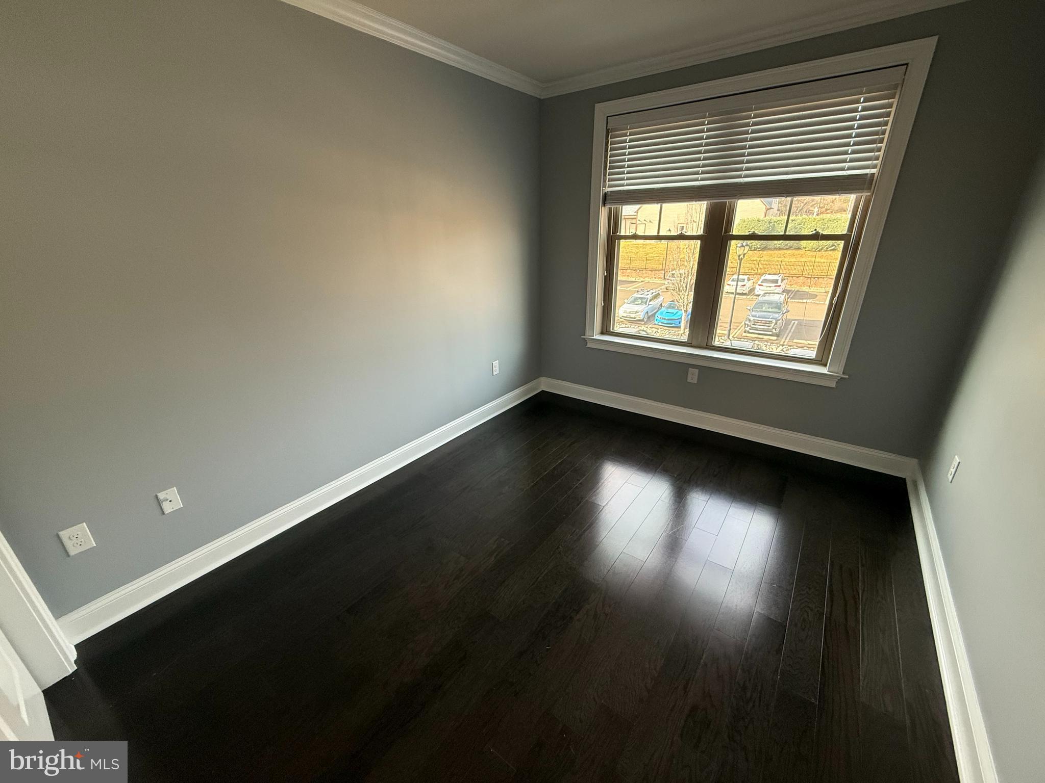 200 North Sycamore Street, Unit 2I Newtown, PA 18940 - Photo 23 of 27 an empty room with wooden floor and windows