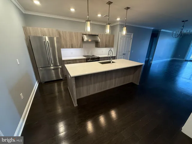 a kitchen with a sink stainless steel appliances and cabinets