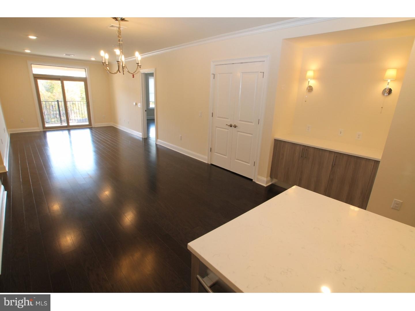 200 North Sycamore Street, Unit 2I Newtown, PA 18940 - Photo 7 of 27 a view of a livingroom with a chandelier