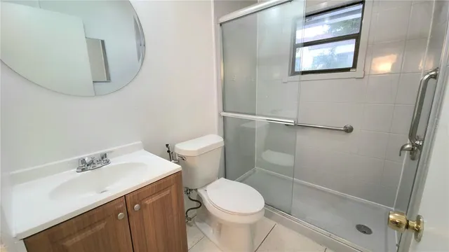 a white toilet sitting next to a bathroom sink