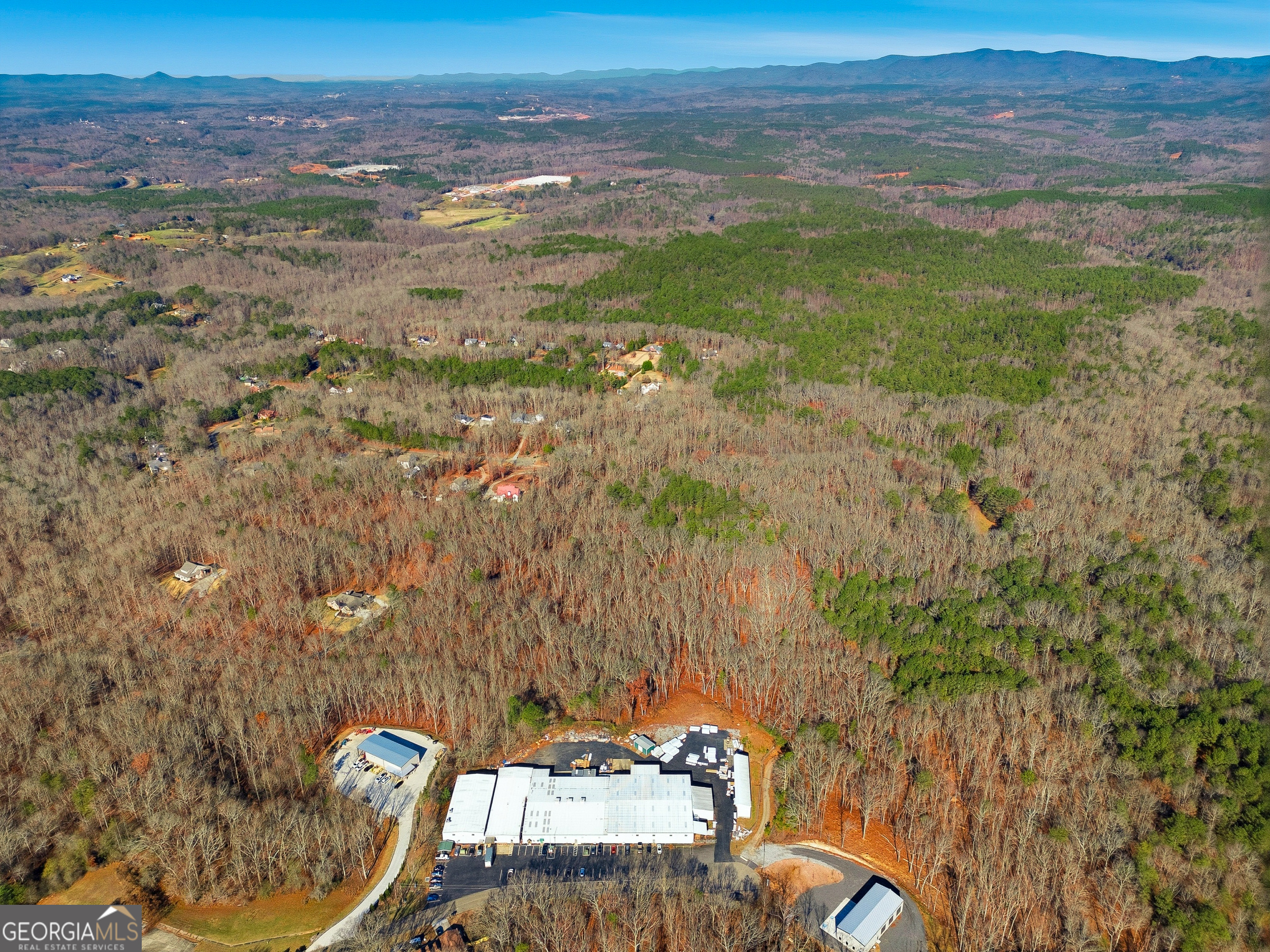209 Hogan Pond Lane Ball Ground, GA 30107 - Photo 2 of 6 a view of a balcony with chair and table
