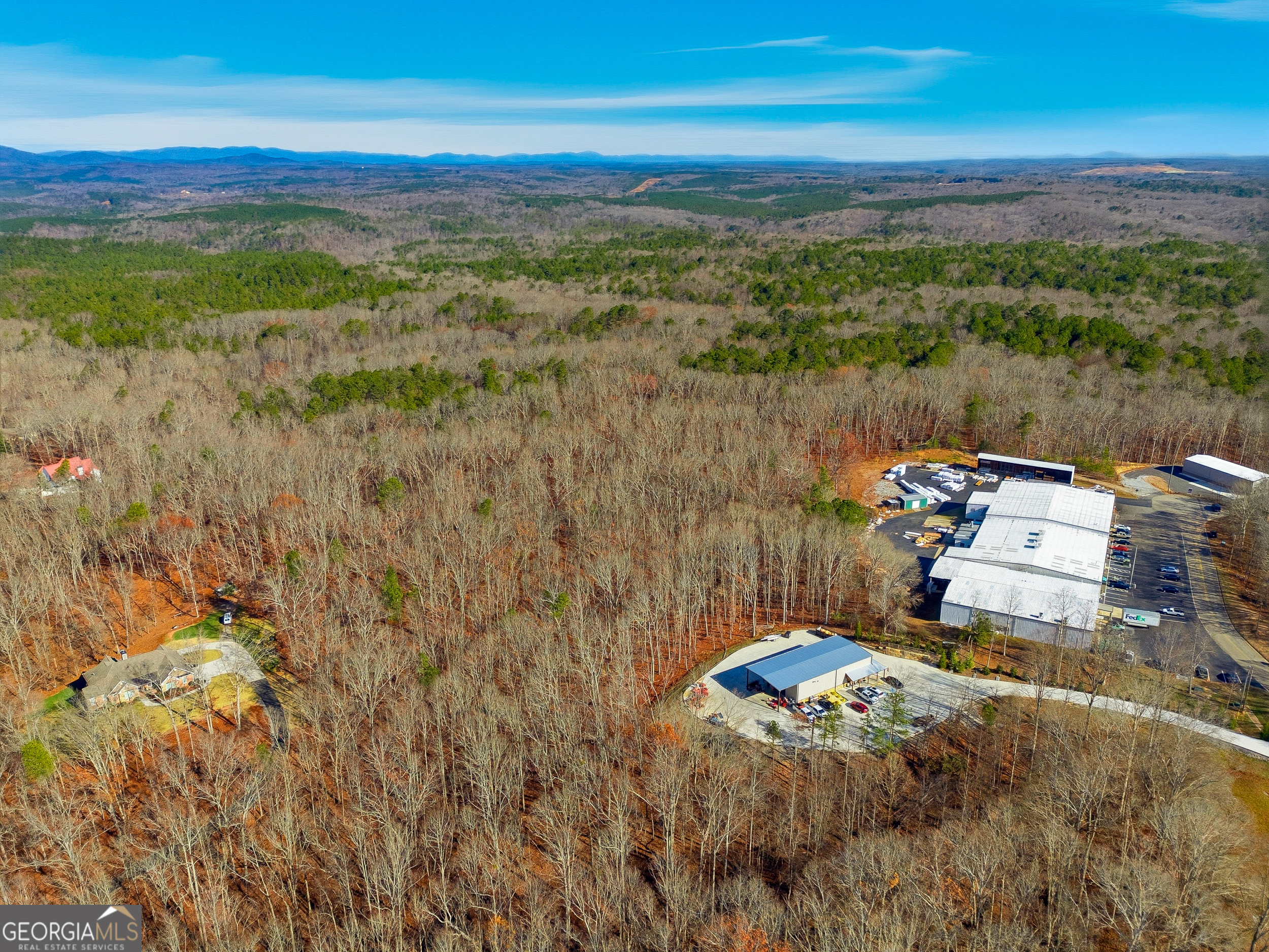 209 Hogan Pond Lane Ball Ground, GA 30107 - Photo 3 of 6 a view of a lake with a mountain
