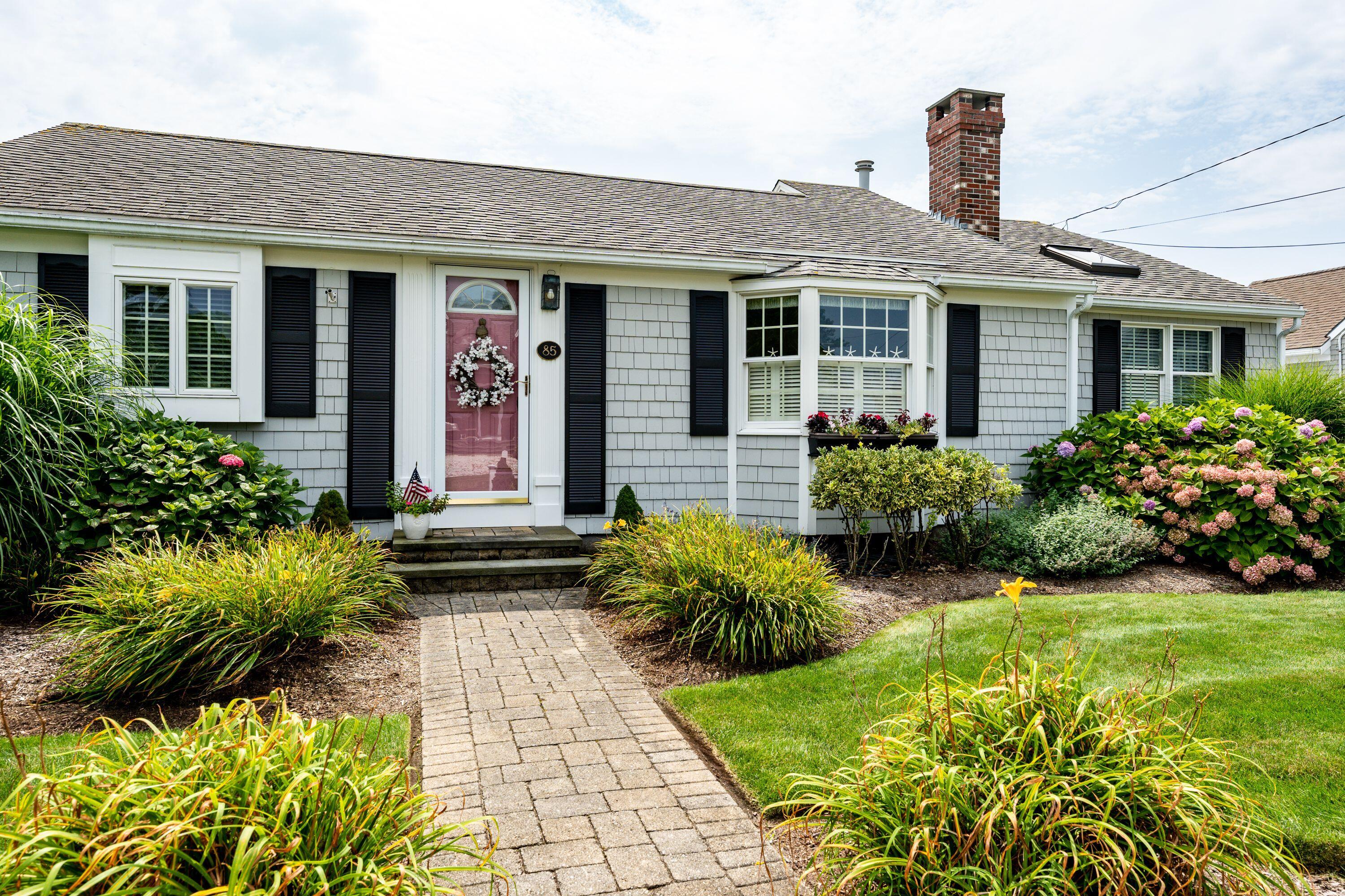 85 Surfside Road West Dennis, MA 02670 - Photo 1 of 34 a front view of house with yard and green space