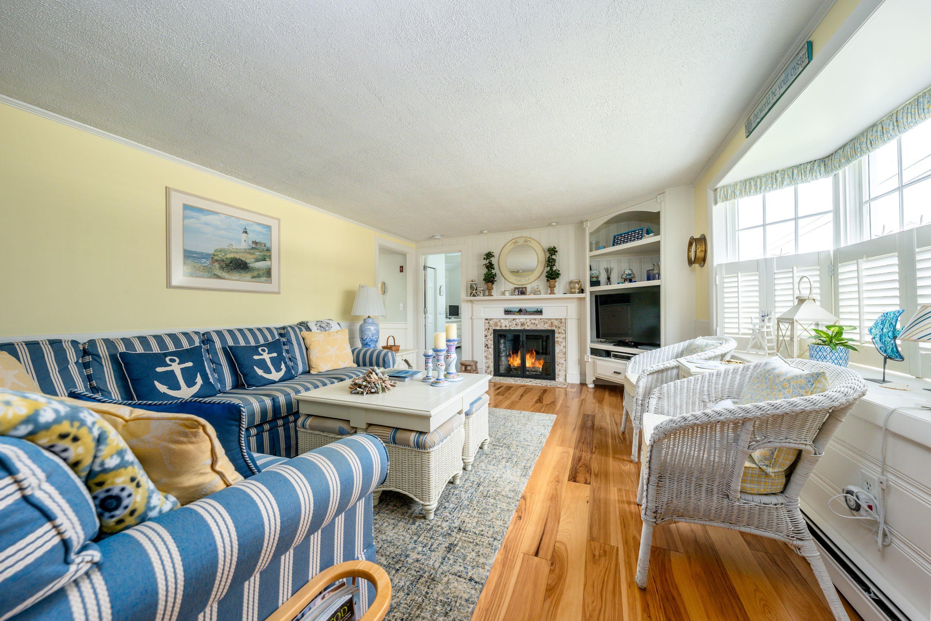 85 Surfside Road West Dennis, MA 02670 - Photo 12 of 34 a living room with furniture fireplace and a table