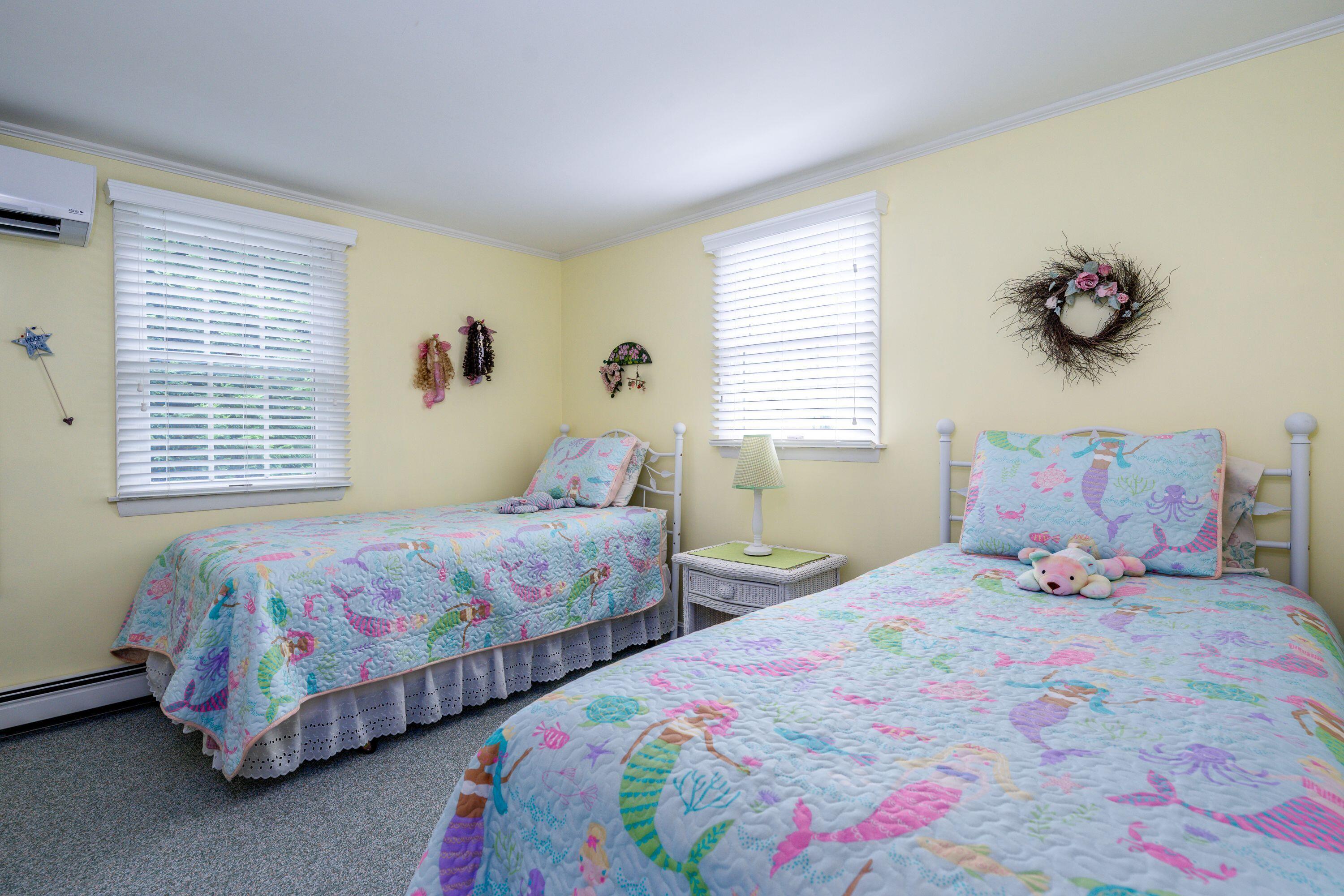 85 Surfside Road West Dennis, MA 02670 - Photo 17 of 34 a bedroom with two beds and a window