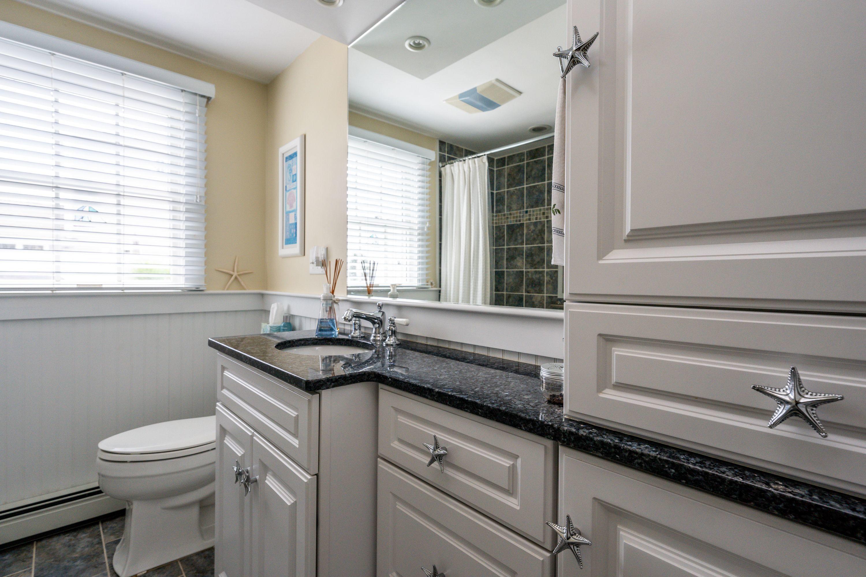 85 Surfside Road West Dennis, MA 02670 - Photo 20 of 34 a bath room with a sink and a toilet