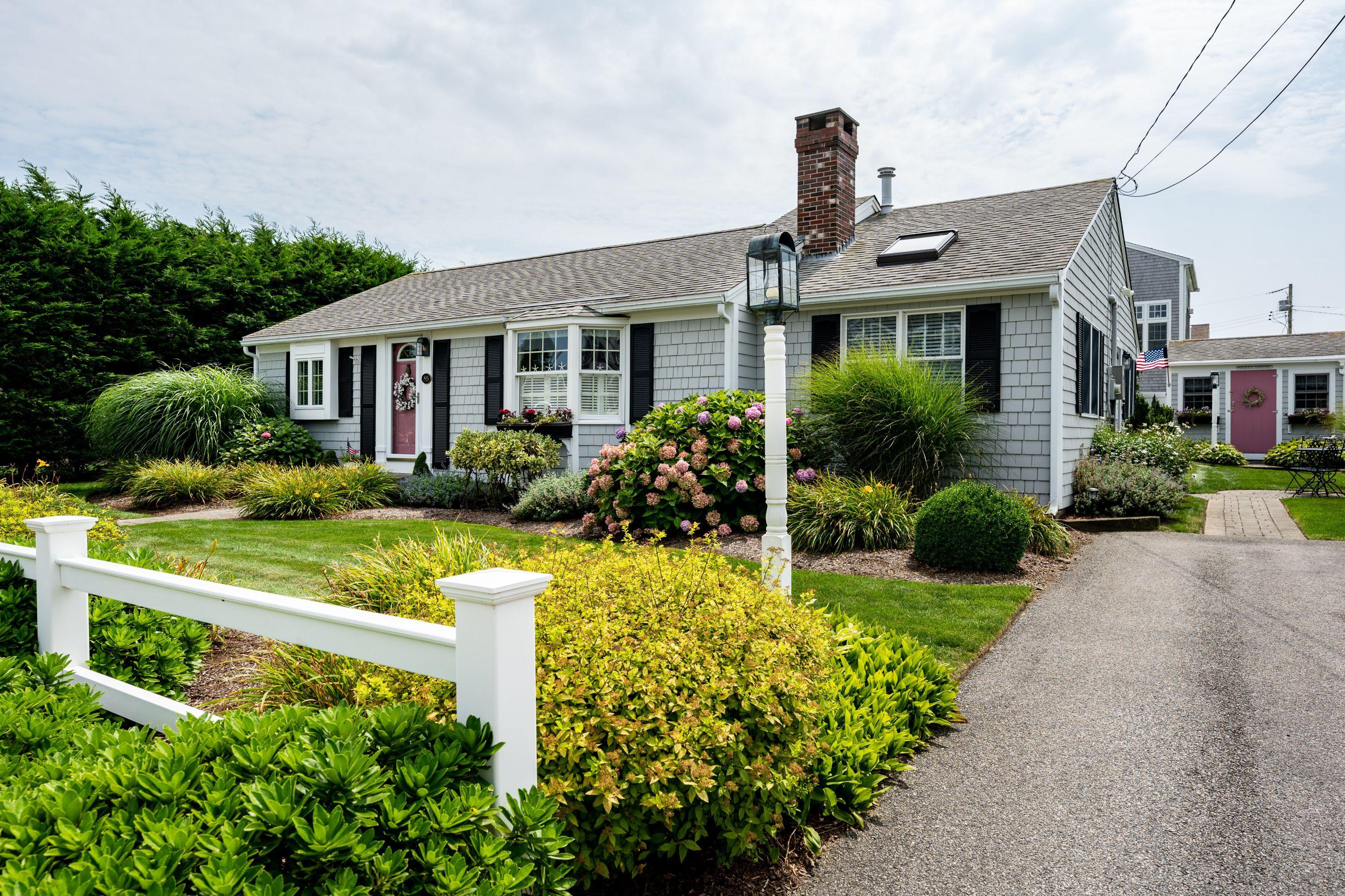 85 Surfside Road West Dennis, MA 02670 - Photo 2 of 34 a front view of a house with a yard