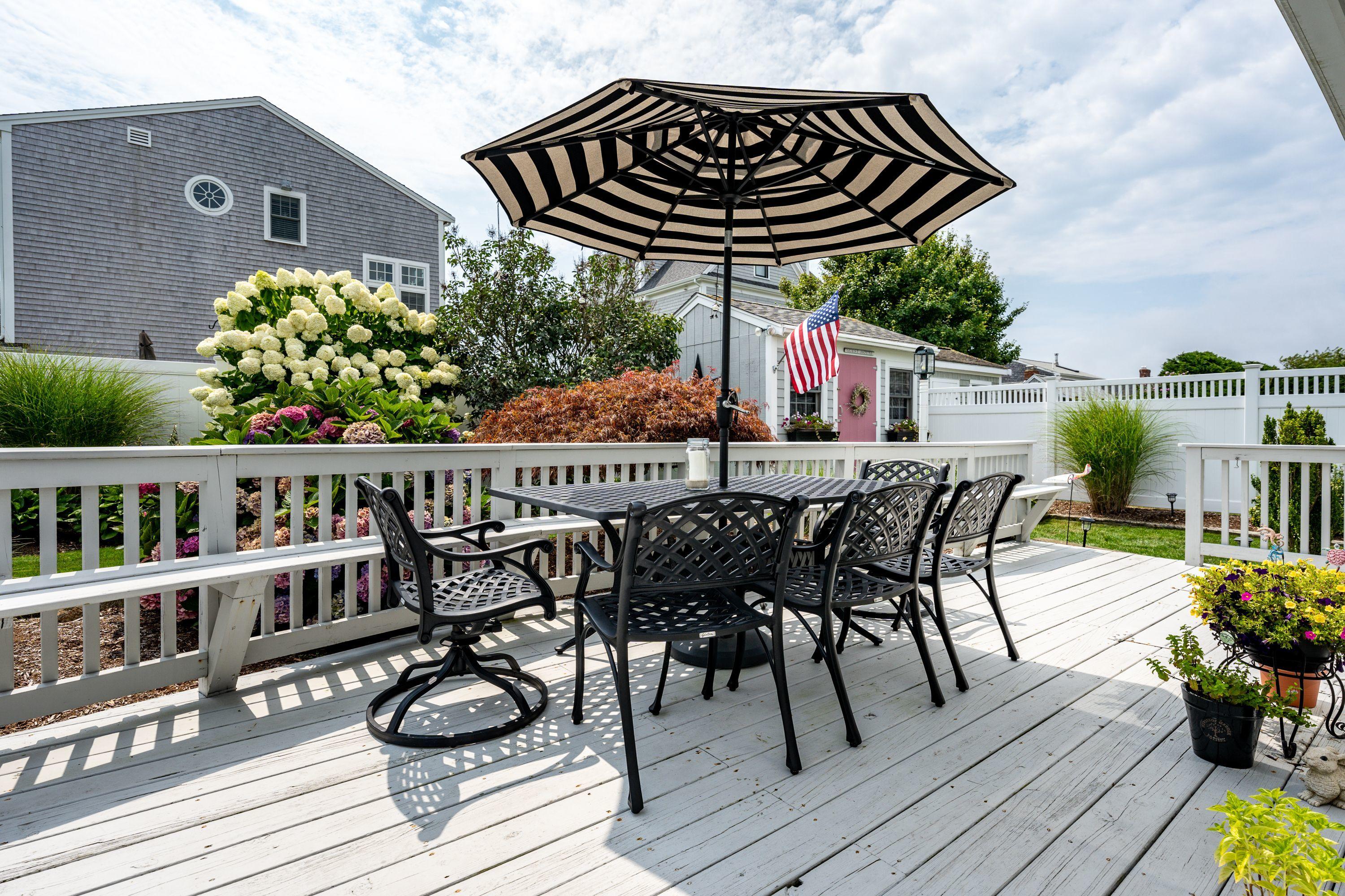 85 Surfside Road West Dennis, MA 02670 - Photo 23 of 34 a view of a chairs and table on the deck