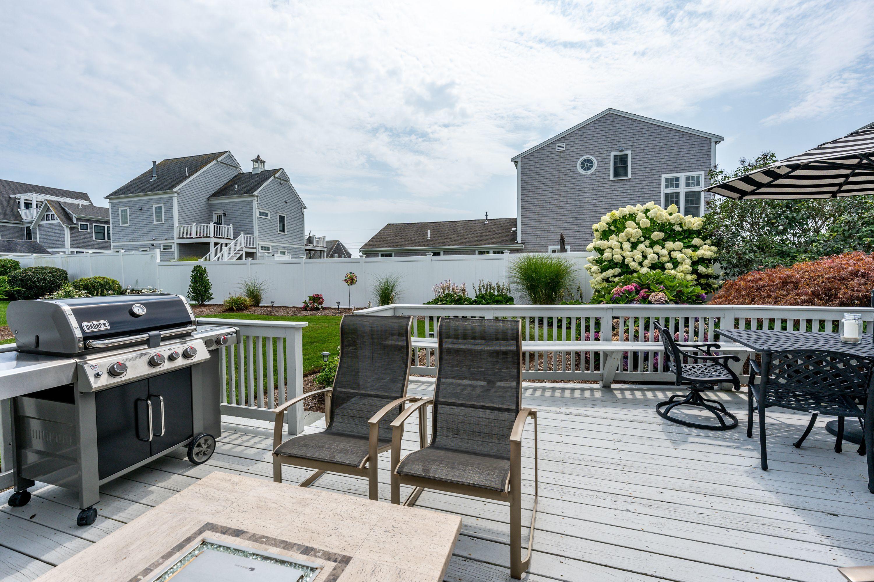 85 Surfside Road West Dennis, MA 02670 - Photo 24 of 34 a view of a chairs and table on the terrace