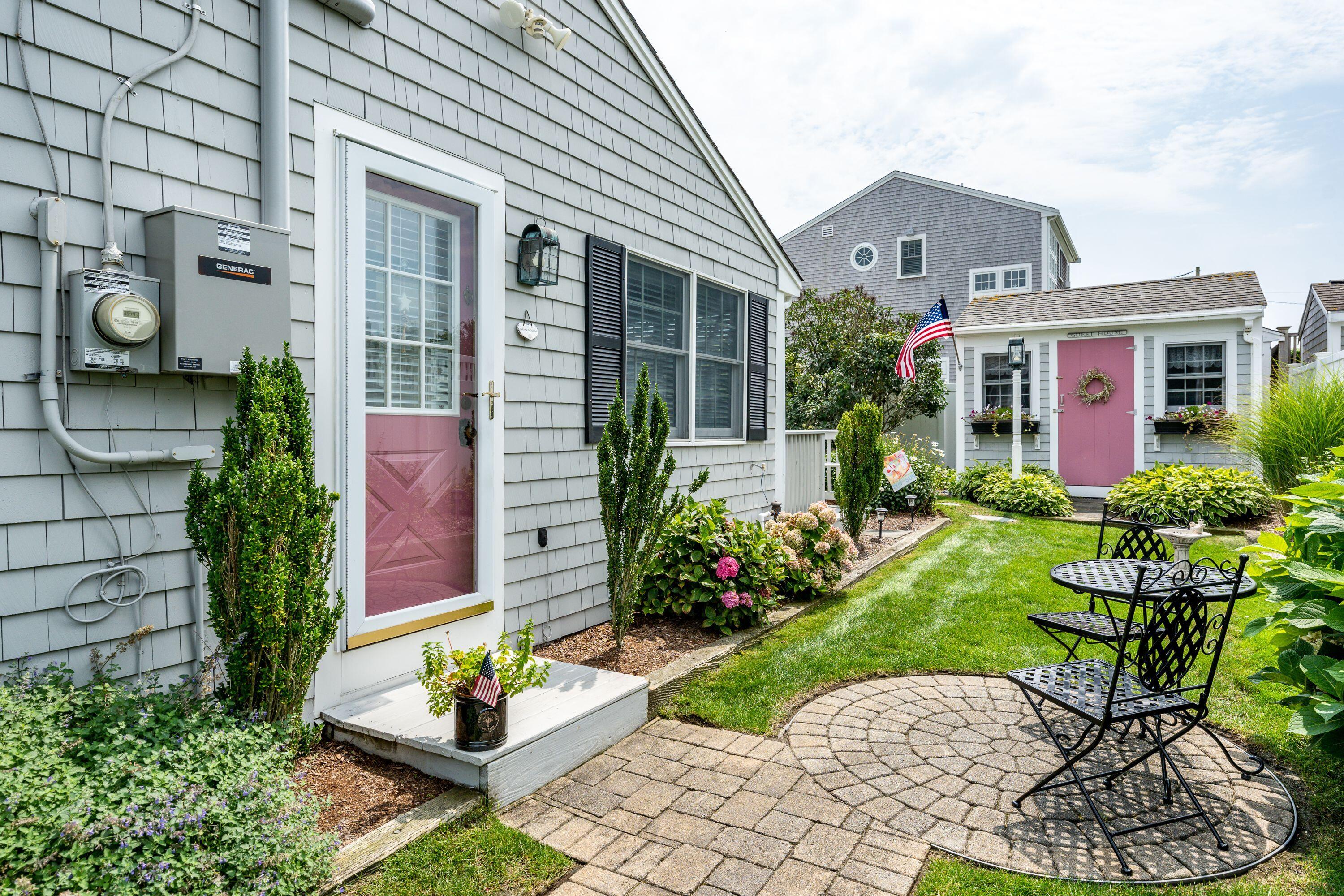 85 Surfside Road West Dennis, MA 02670 - Photo 27 of 34 a front view of a house with a garden