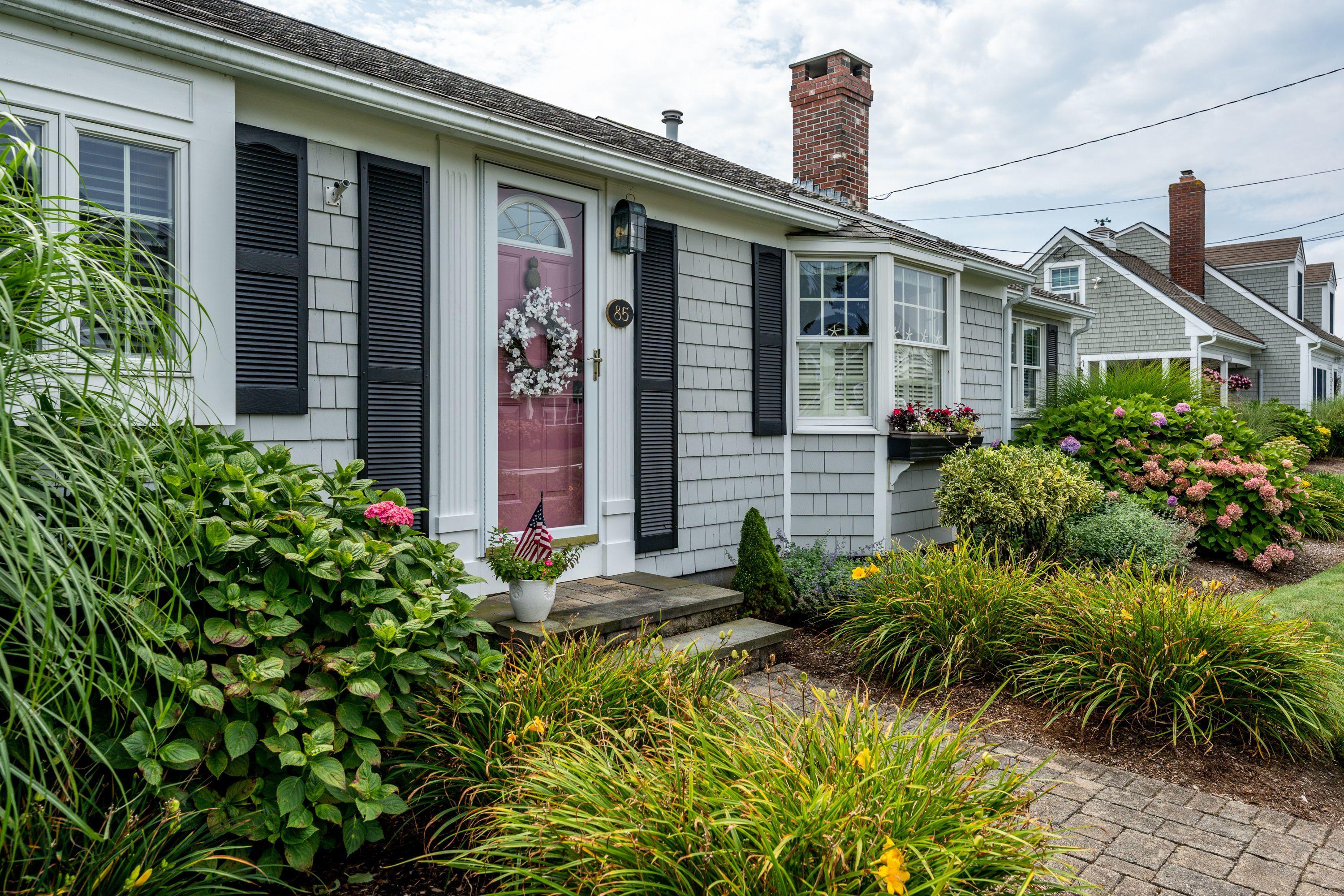 85 Surfside Road West Dennis, MA 02670 - Photo 28 of 34 front view of a house with potted plants