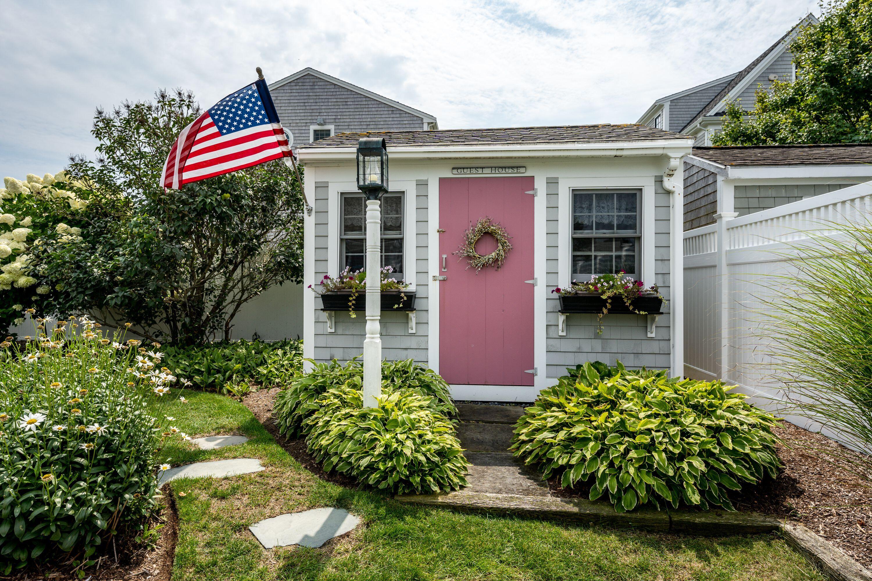 85 Surfside Road West Dennis, MA 02670 - Photo 3 of 34 a front view of a house with garden