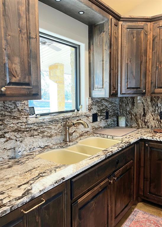 6601 Rash Court Granbury, TX 76049 - Photo 11 of 23 a bathroom with a granite countertop sink and a mirror