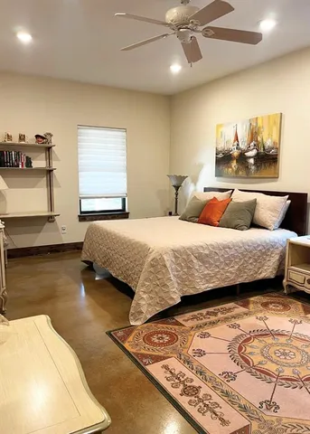 a bedroom with a bed and ceiling fan