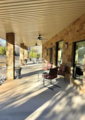 a living room with patio furniture and a fireplace