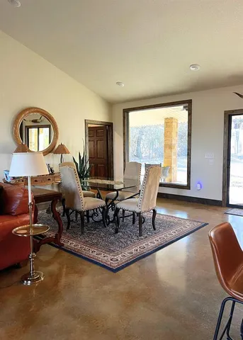 a living room with furniture a window and a table