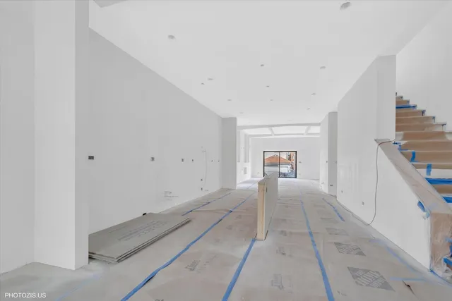 a view of a hallway with wooden floor and a cabinet