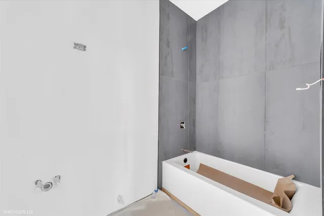 a bathroom with a tub and mirror