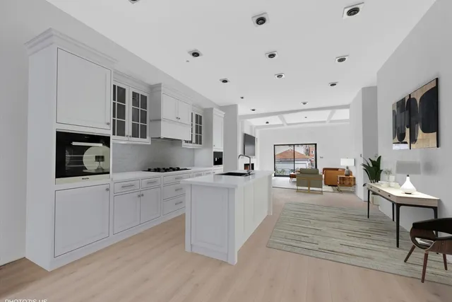 a kitchen with stainless steel appliances granite countertop a stove top oven a sink dishwasher and white cabinets with wooden floor