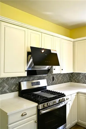 a kitchen with wooden floors and white appliances