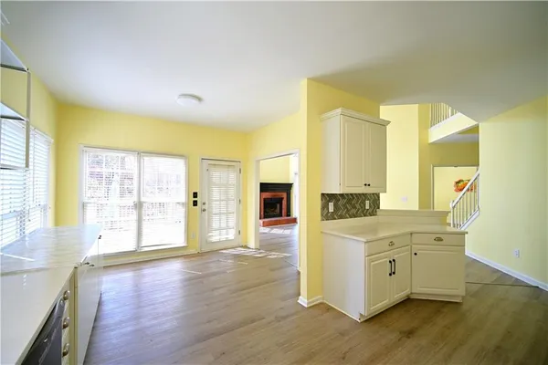 an empty room with wooden floor and closet