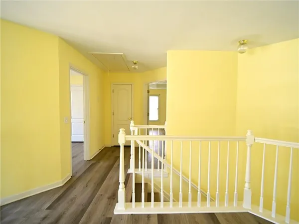 a view of an empty room with window wooden floor and a fire place