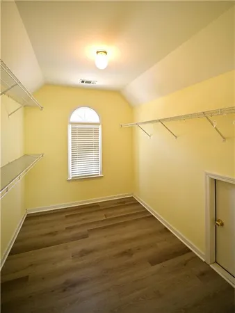 a spacious bathroom with a double vanity sink a mirror and a bathtub