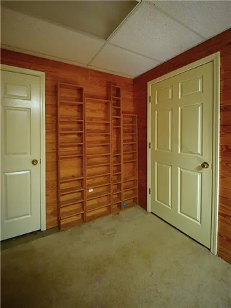 a view of a house with large windows and a tree