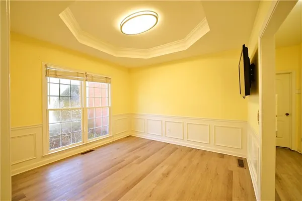 a view of an empty room with a fireplace and a window