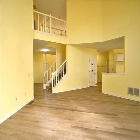 a large kitchen with a wooden floor and outdoor space