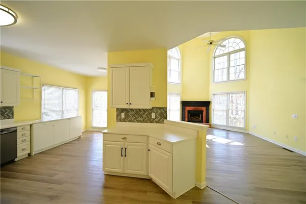 a living room with stainless steel appliances furniture stove and a kitchen view