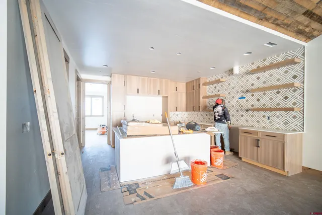 a view of a livingroom with fireplace and window