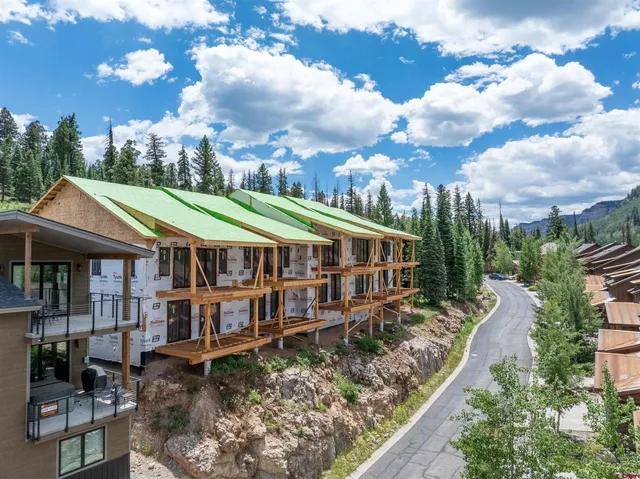 an aerial view of a house with a yard and balcony