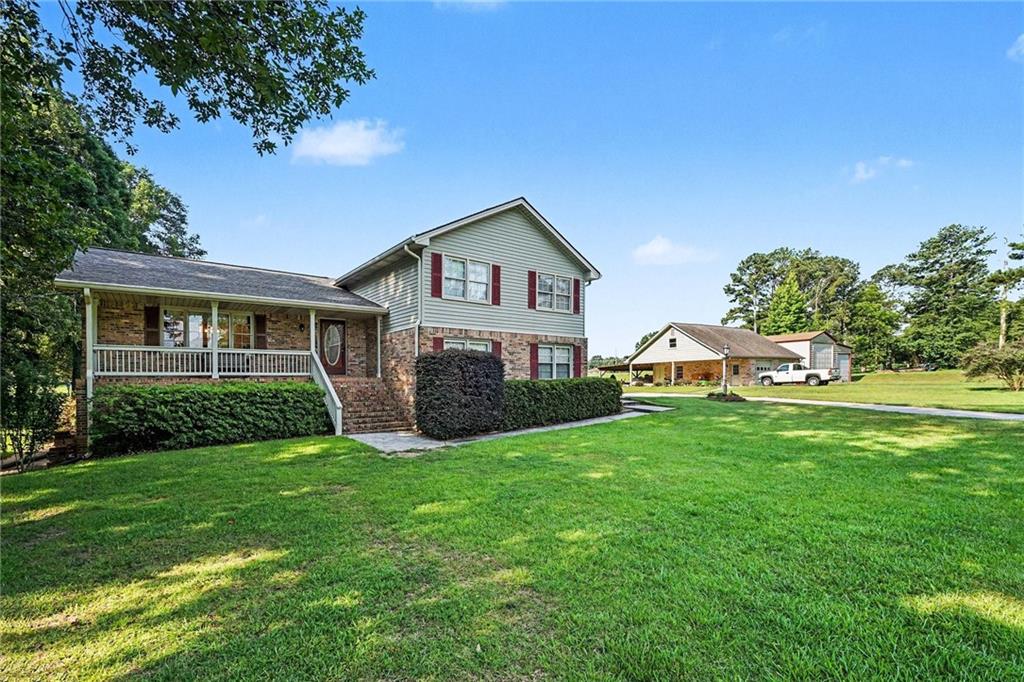 740 Smyrna Road Southwest Conyers, GA 30094 - Photo 2 of 27 a front view of a house with a yard and garage