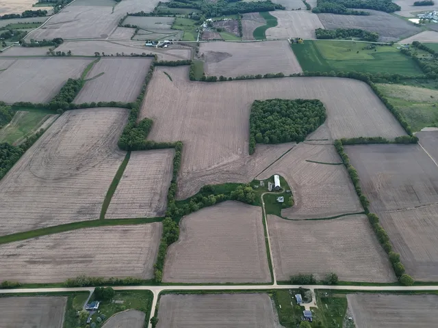 an aerial view of a house with yard