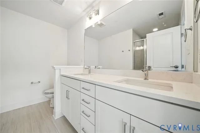 a bathroom with a double vanity sink and a mirror
