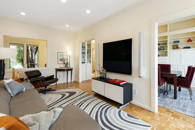 a view of a hallway with wooden floor and windows