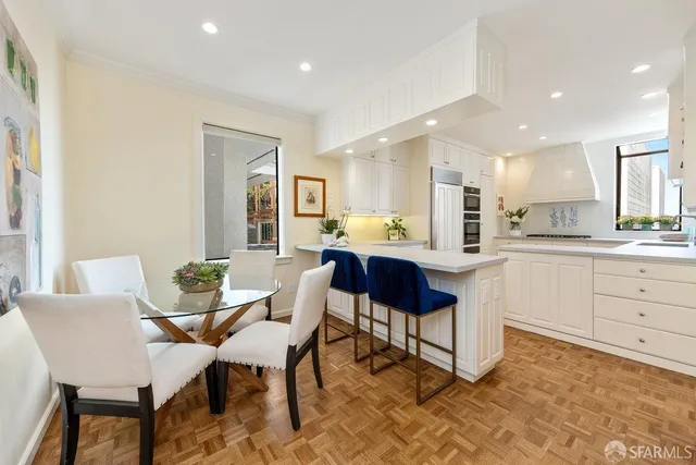 a view of a patio with couches table and chairs and potted plants