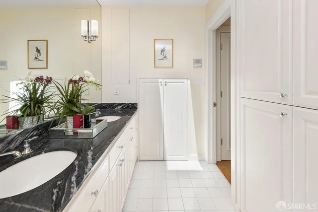 a view of a patio with couches chairs potted plants and city view